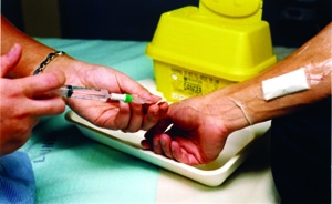 Antibiotics being injected into the long lines of a patient with cystic fibrosis